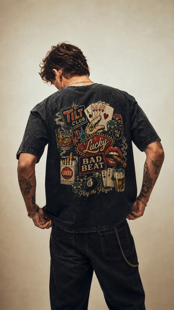 Model wearing the back design of the Tilted Gambler acid wash tee, Tilted Spades