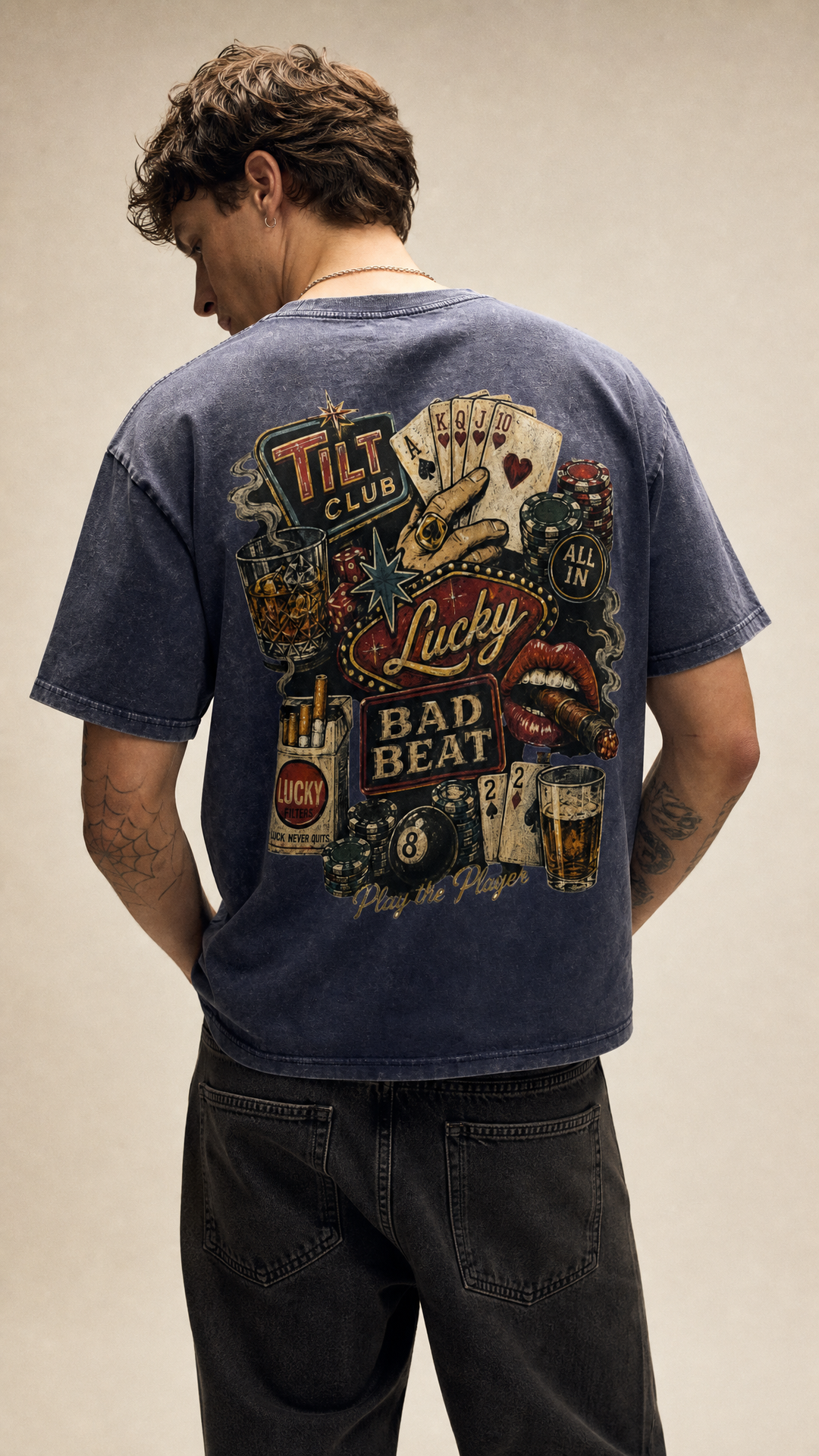 Model wearing the back design of the Tilted Gambler acid wash tee in another pose, Tilted Spades