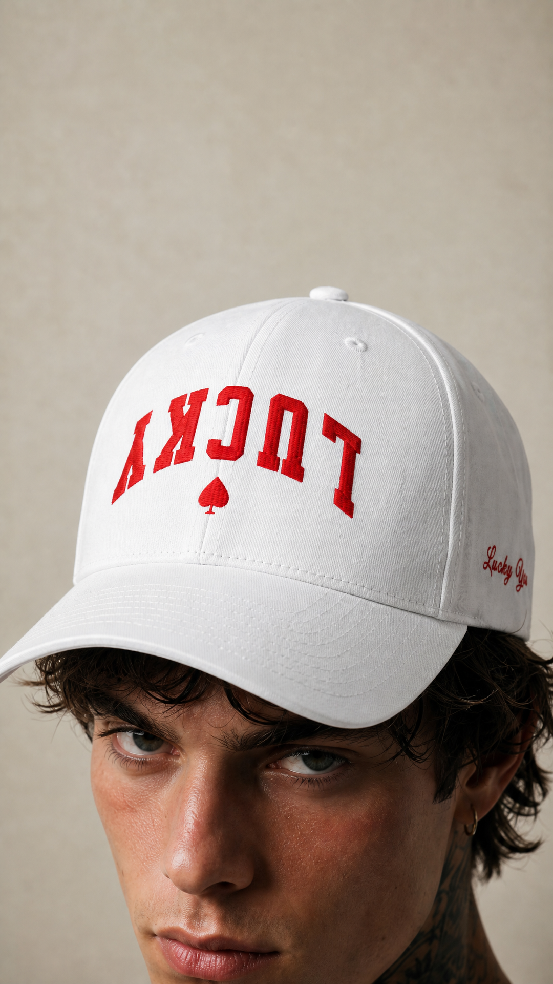 Close-up of the white Lucky Spade cap with red embroidery, Tilted Spades