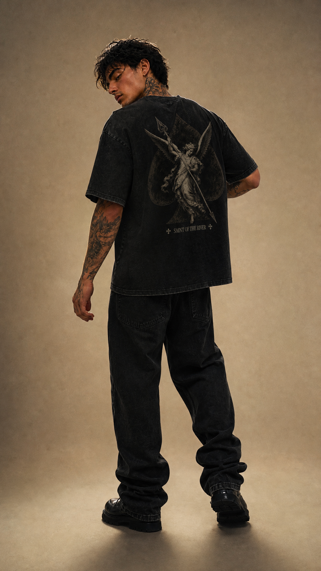 Model wearing the back design of the River Saint tee, white studio, Tilted Spades