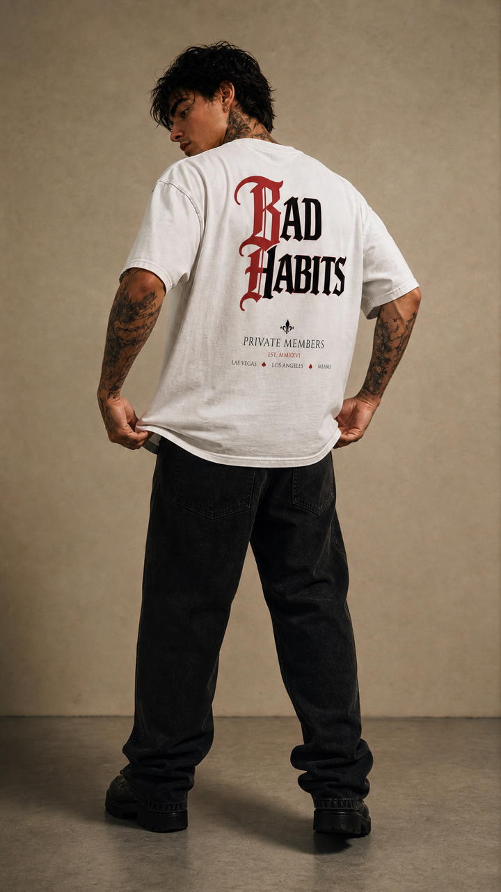 Model wearing the back design of the Bad Habits enzyme washed tee, white studio, Tilted Spades
