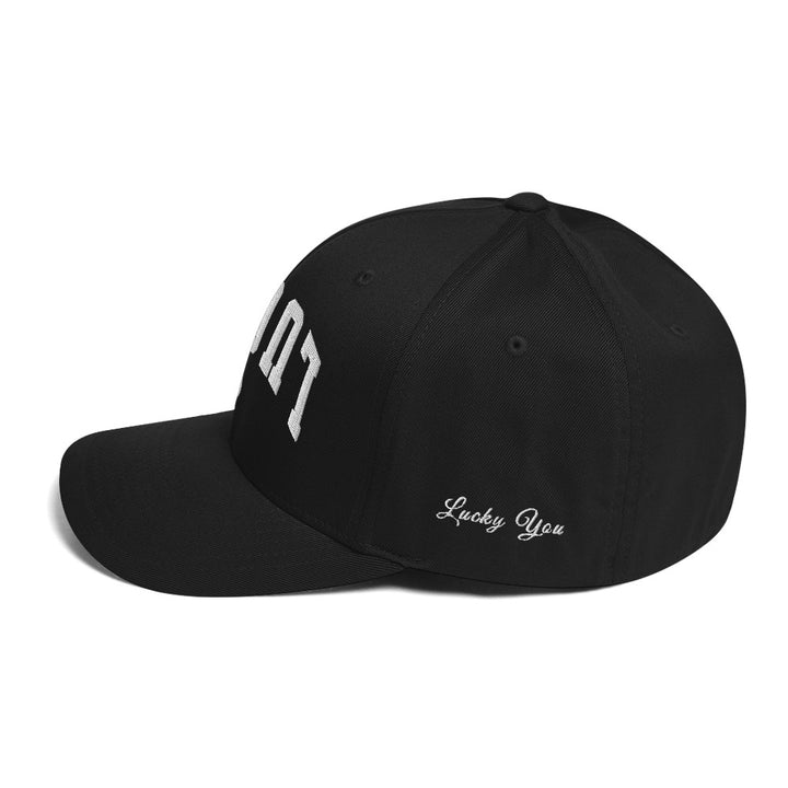 Black closed-back structured cap mockup, left side view, Tilted Spades